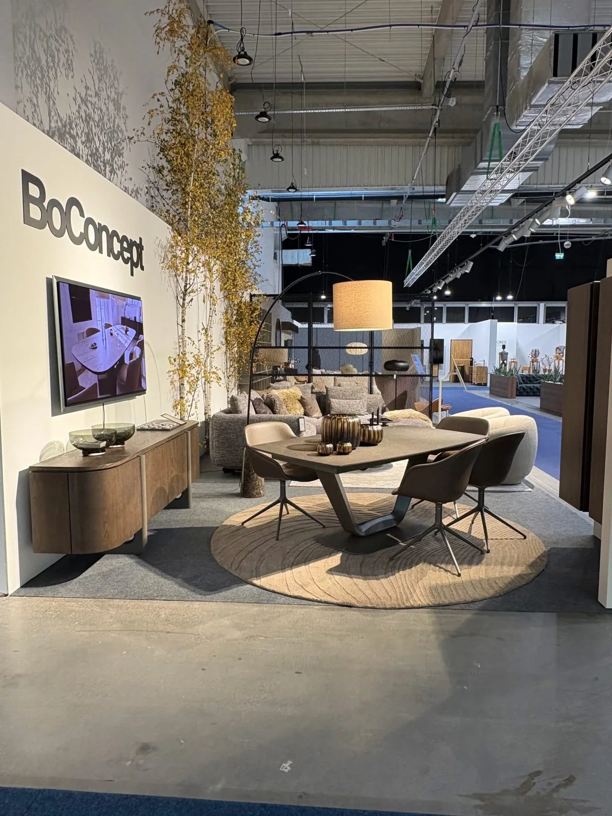 Stoisko BoConcept z jasną sofą i naturalnymi dodatkami