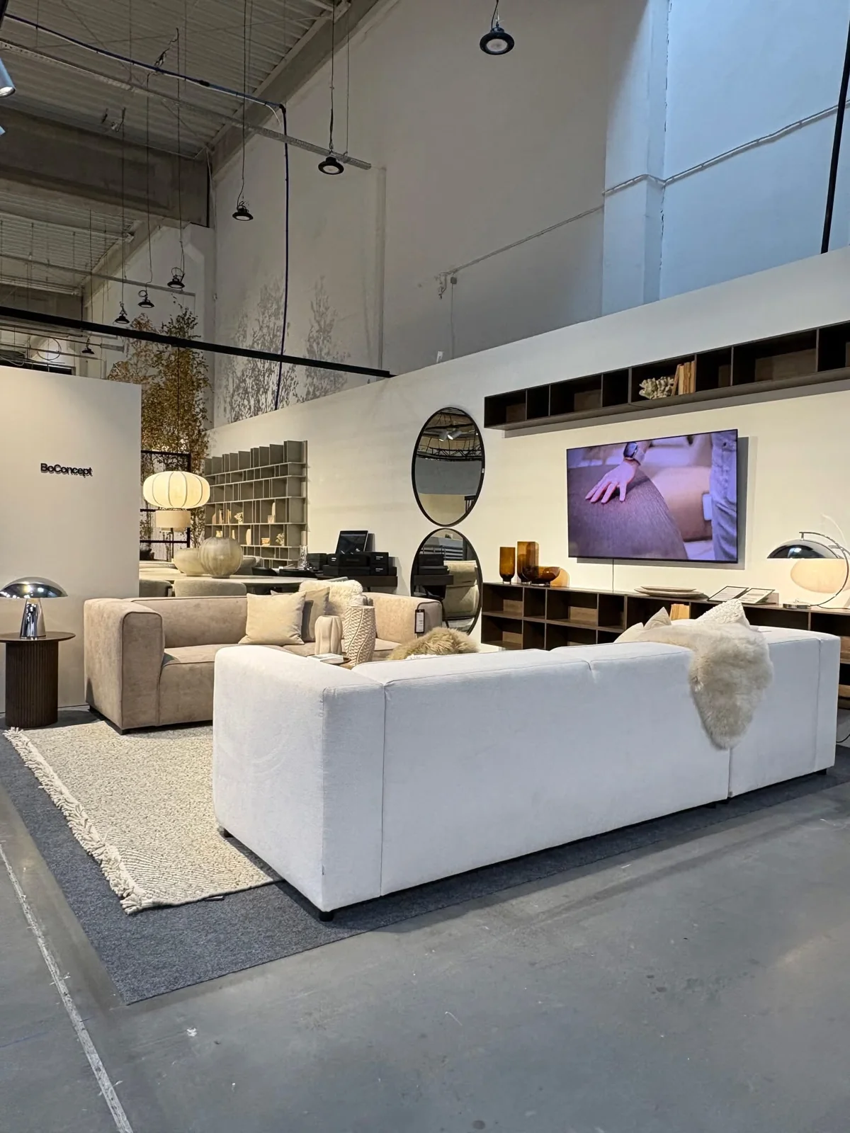 Aranżacja salonu BoConcept z narożnikiem i naturalnymi dekoracjami